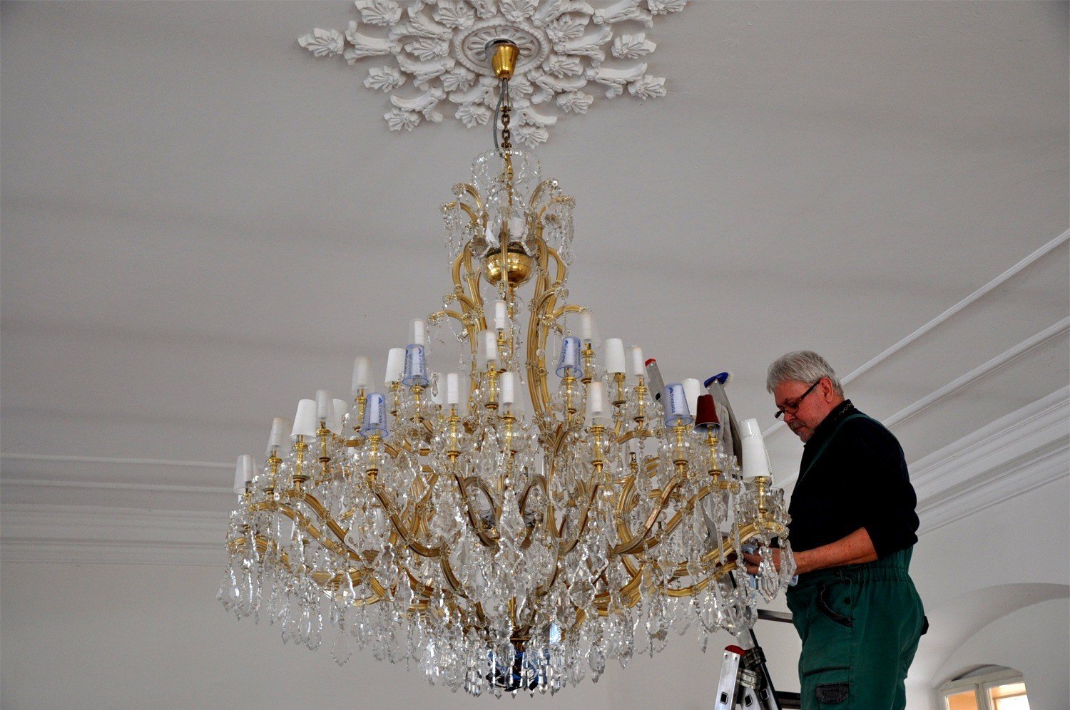 Professional chandelier cleaning in progress in Dubai