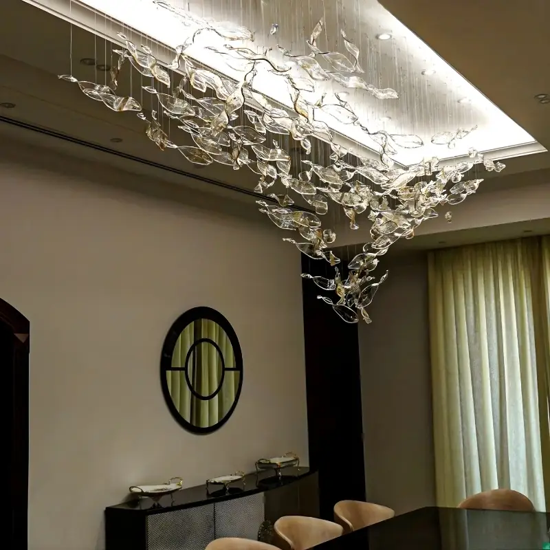 double-height staircase chandelier installation, Al Barari
